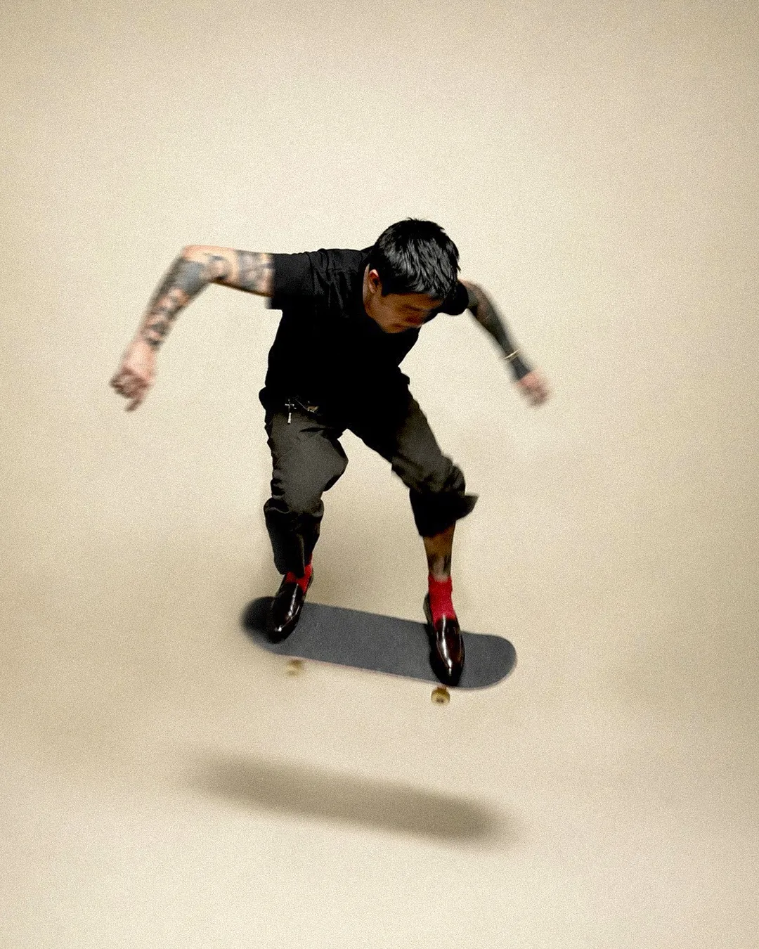 Lalo mid-air on a skateboard, shot from above