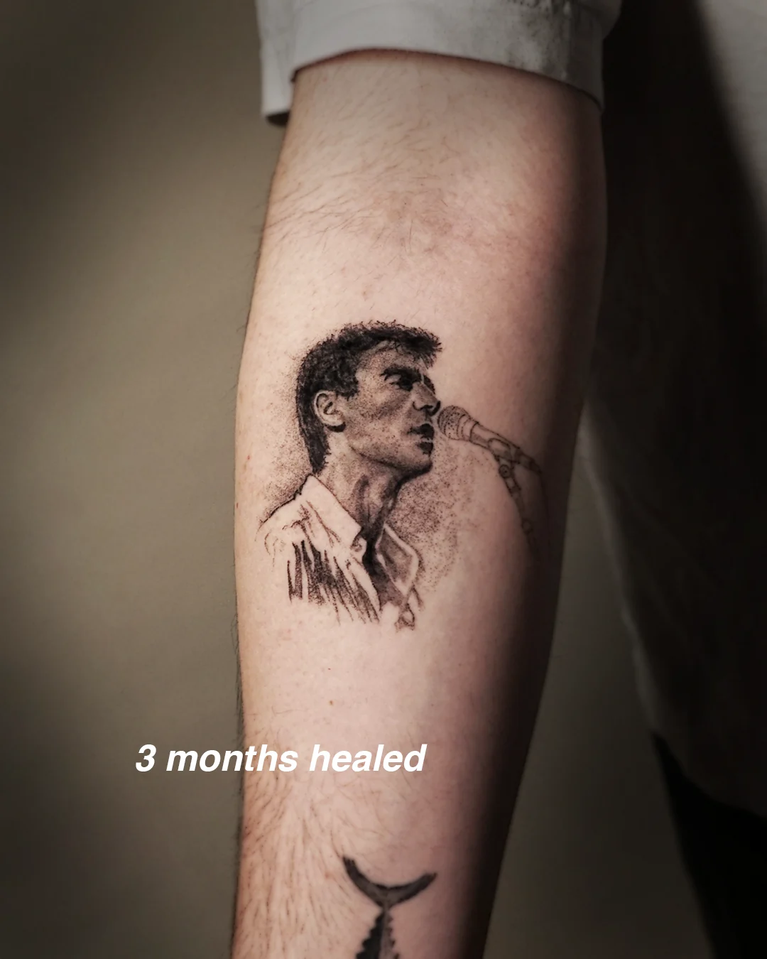 Black and grey micro-realism portrait of a singer at a microphone, healed three months
